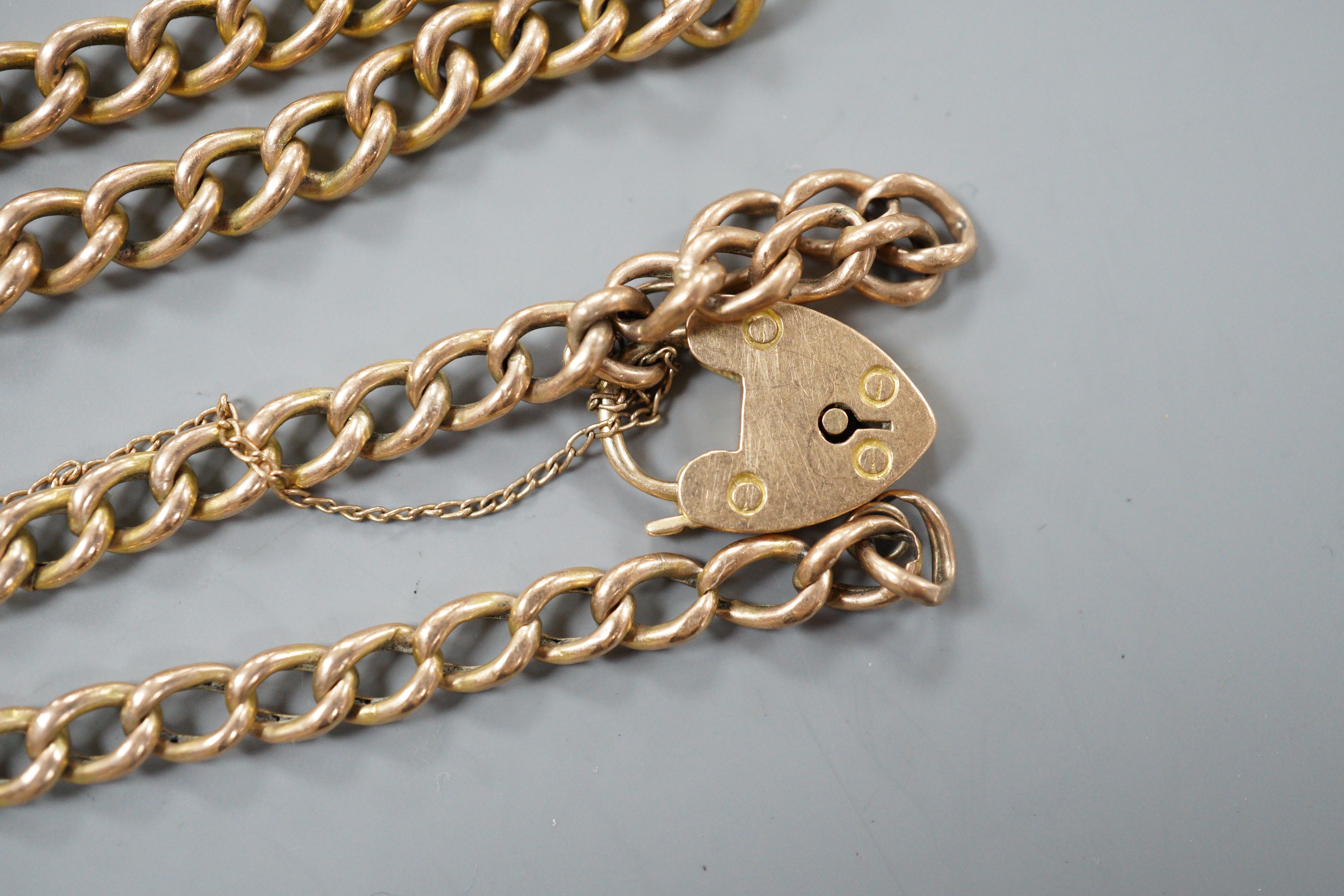 A 9ct curb link bracelet and a yellow metal curb link bracelet with 15ct clasp, gross weight 10.1 grams.